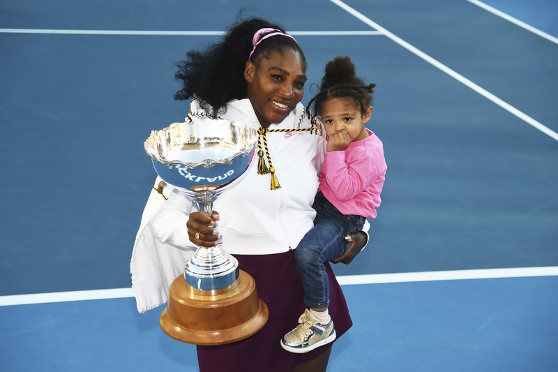 Serena Williams from the United States smiles while holding her daughter Alexis Olympia Ohanian Jr. and the ASB trophy after winning her singles finals match against United States Jessica Pegula at the ASB Classic in Auckland, New Zealand, Sunday. - Photo by Chris Symes of Photosport via The Associated Press story.lead_photo.caption