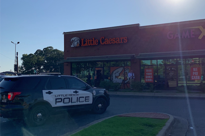 FILE - A police cruiser sits outside a Little Caesars Pizza, 3412 S. University Ave. on Aug. 29, 2019 in Little Rock.