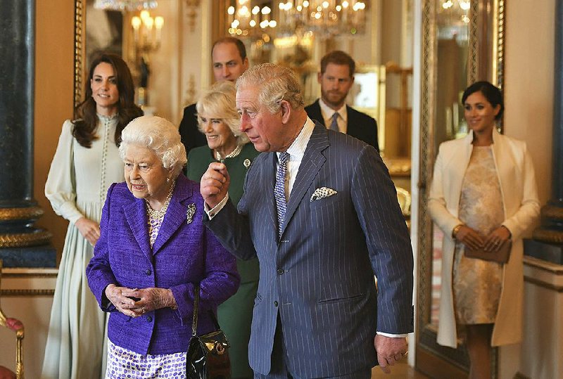 Britain’s Queen Elizabeth II (front left), shown last year with members of the royal family, said in a statement Monday that “there will be a period of transition” as Harry and Meghan spend time in both Canada and the U.K. More photos at arkansasonline. com/114queen/.