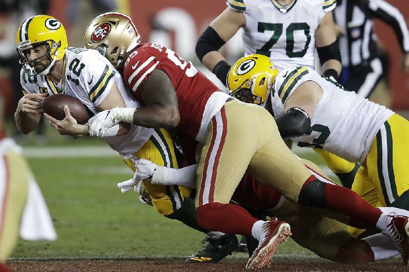 Green Bay quarterback Aaron Rodgers is sacked by San Francisco defensive tackle DeForest Buckner during a Nov. 24 game in Santa Clara, Calif. The Packers were overwhelmed from the start in that matchup, but they have won six in a row coming into Sunday’s rematch with the 49ers in the NFC Championship Game.
