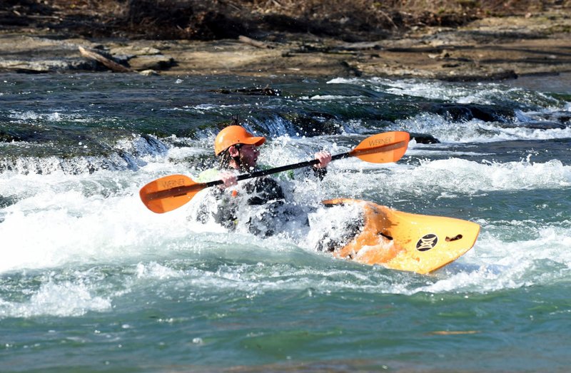 NWA Democrat-Gazette/FLIP PUTTHOFF Phillip Riggins enjoys whitewater thrills on Dec. 21 2019 at the Siloam Springs Kayak Park on the Illinois River. Winter is a prime whitewater season for paddlers who are geared up for it.