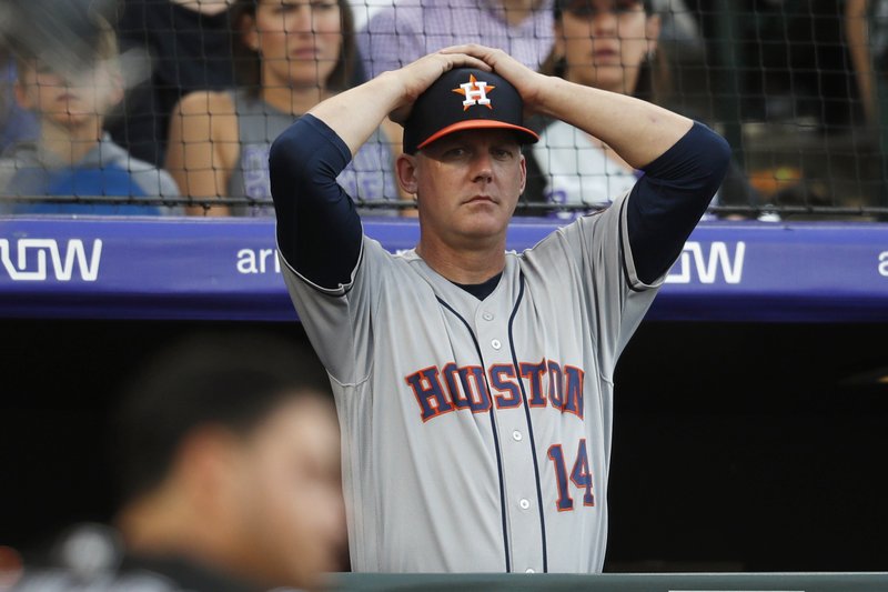 Houston Astros manager AJ Hinch reacts during a July 2, 2019, game against the Colorado Rockies, in Denver. Hinch and general manager Jeff Luhnow were suspended for the entire season Monday, and the team was fined $5 million for sign-stealing by the team in 2017 and 2018 season. Commissioner Rob Manfred announced the discipline and strongly hinted that current Boston manager Alex Cora -- the Astros bench coach in 2017 -- will face punishment later. Manfred said Cora developed the sign-stealing system used by the Astros. - Photo by David Zalubowski of The Associated Press story.lead_photo.caption