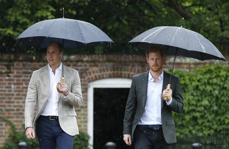 FILE - In this Wednesday, Aug. 30, 2017 file photo, Britain's Prince William, left, and Prince Harry arrive for an event at the memorial garden in Kensington Palace, London. Britain's Queen Elizabeth II is set to hold face-to-face talks Monday, Jan. 13, 2020 with Prince Harry for the first time since he and his wife, Meghan, unveiled their controversial plan to walk away from royal roles &#x2014; at a dramatic family summit meant to chart a future course for the couple. The meeting at the monarch's private Sandringham estate in eastern England will also include Harry's father Prince Charles and his brother Prince William. (AP Photo/Kirsty Wigglesworth, File)