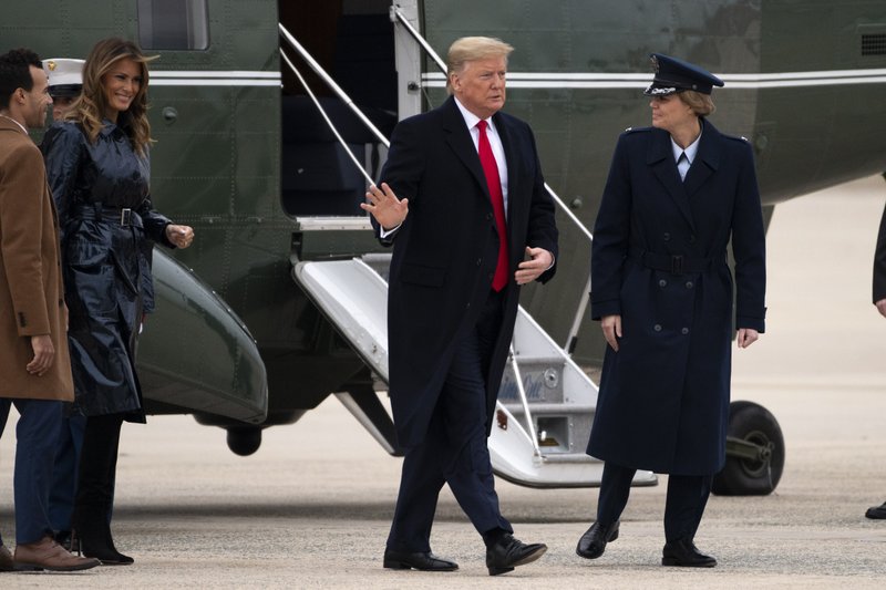 President Donald Trump and first lady Melania Trump exit Marine One on Monday, Jan. 13, 2020, at Andrews Air Force Base, Md., as he travels to attend the College Football National Championship game in New Orleans. (AP Photo/Kevin Wolf)
