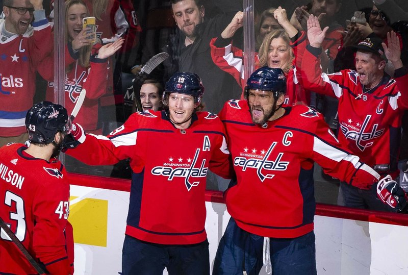 Washington Capitals left wing Alex Ovechkin (8), from Russia, celebrates after scoring as right wing Tom Wilson (43), from Canada, and Nicklas Backstrom (19), from Sweden, join during the first period of Monday's game against the Carolina Hurricanes in Washington. - Photo by Al Drago of The Associated Press story.lead_photo.caption