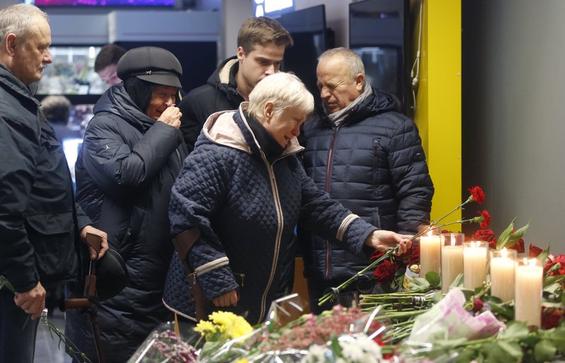 Relatives of one of the flight crew members of the Ukrainian 737-800 plane that crashed on the outskirts of Tehran, stand at a memorial inside Borispil international airport outside Kyiv, Ukraine, Saturday, Jan. 11, 2020. Ukraine's President Volodymyr Zelenskiy says that Iran must take further steps following its admission that one of its missiles shot down Ukrainian civilian airliner. (AP Photo/Efrem Lukatsky)
story.lead_photo.caption