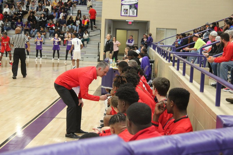  Magnolia head coach Ben Lindsey discusses something with players on the bench (Photo by Chris Gilliam)