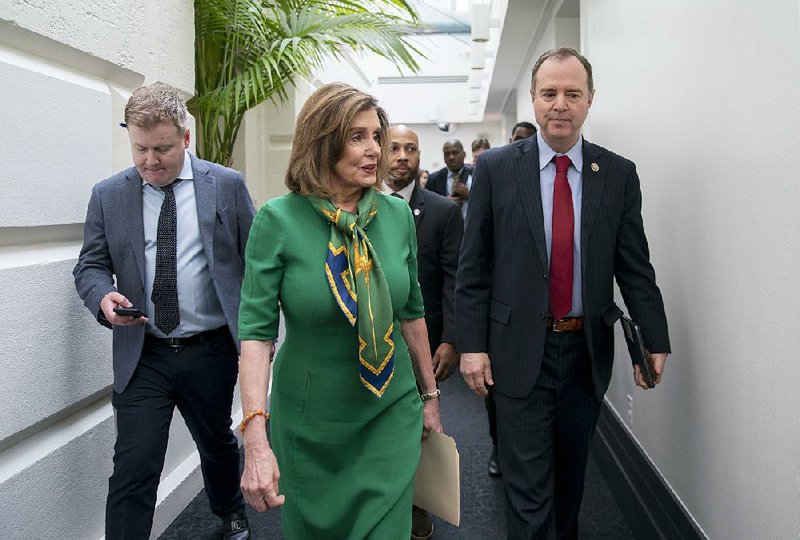 House Speaker Nancy Pelosi and House Intelligence Committee Chairman Adam Schiff leave a private meeting Tuesday with House Democrats during which Pelosi fi rst announced her plan for today’s vote on starting the impeachment trial process. More photos at arkansasonline.com/115pelosi/.
(AP/J. Scott Applewhite)