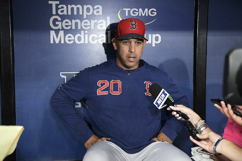 Boston Red Sox manager Alex Cora (20) answers questions from reporters in the dugout before a baseball game against the Tampa Bay Rays Friday, Sept. 20, 2019, in St. Petersburg, Fla. 
(AP Photo/Phelan M. Ebenhack)