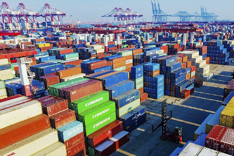 Hundreds of containers sit stacked Tuesday at the port in Qingdao, China. Despite today’s scheduled signing of an initial U.S.-China trade deal, tariffs on billions of dollars of imported Chinese goods will likely stay in place until after the presidential election, according to sources.
(AP)