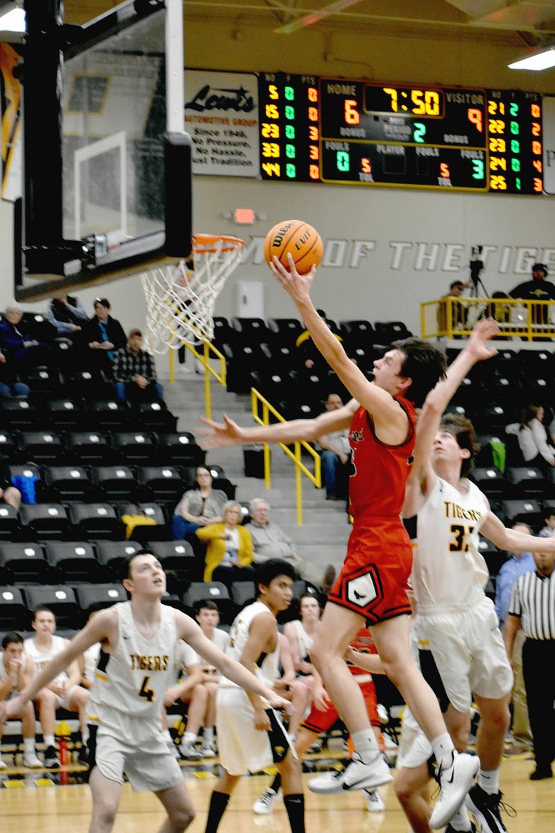 ENTERPRISE-LEADER photograph by Mark Humphrey Blackhawk senior Wes Wales spins left and scores going to the basket after posting up during a conference game won by the Blackhawks, 56-39, at Prairie Grove's Tiger Arena in a rescheduled game played Monday, Jan. 13.