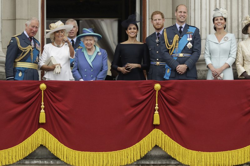 FILE - In this Tuesday, July 10, 2018 file photo, members of the royal family gather on the balcony of Buckingham Palace, with from left, Prince Charles, Camilla the Duchess of Cornwall, Prince Andrew, Queen Elizabeth II, Meghan the Duchess of Sussex, Prince Harry, Prince William and Kate the Duchess of Cambridge, as they watch a flypast of Royal Air Force aircraft pass over Buckingham Palace in London. In a statement issued on Monday, Jan. 13, 2020, Queen Elizabeth II says she has agreed to grant Prince Harry and Meghan their wish for a more independent life that will see them move part-time to Canada. (AP Photo/Matt Dunham, File)