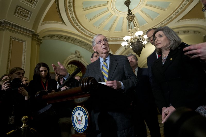 Senate Majority Leader Mitch McConnell, R-Ky., accompanied by Sen. Joni Ernst R-Iowa, and other senators, speaks outside of the Senate chamber, on Capitol Hill in Washington, Tuesday, Jan. 14, 2020. 
(AP Photo/Jose Luis Magana)