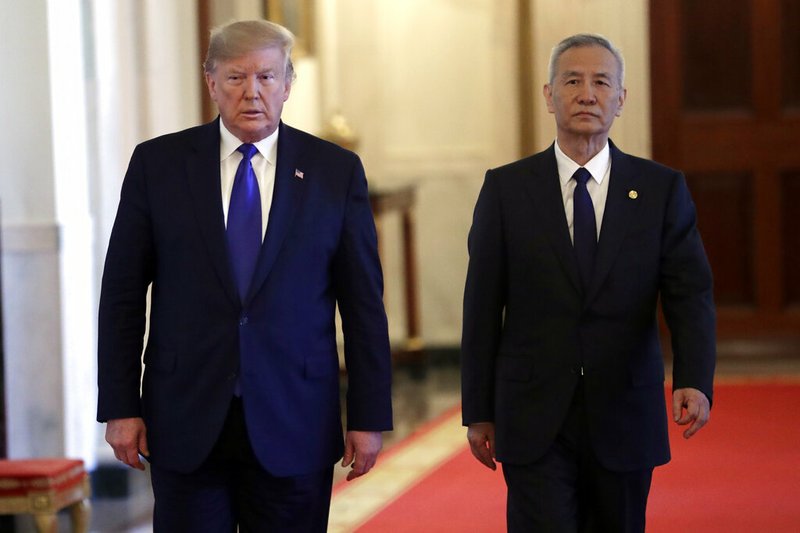 President Donald Trump walks with Chinese Vice Premier Liu He, left, to the East Room of the White House, Wednesday, Jan. 15, 2020, in Washington, to sign a trade agreeement. (AP Photo/ Evan Vucci)