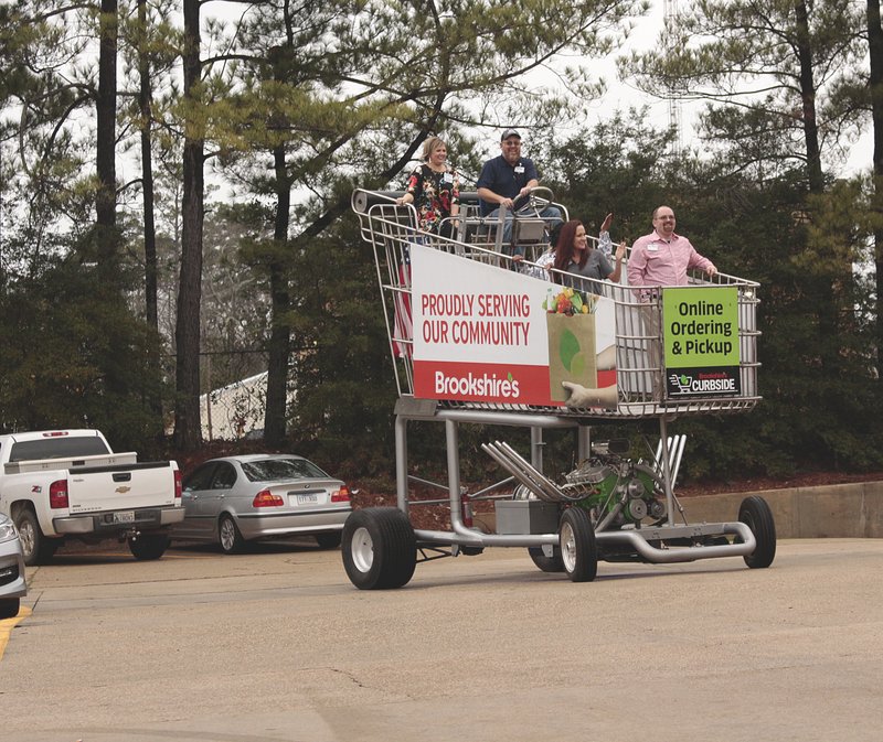 Brookshire’s employees had the opportunity to ride the 13 foot-tall motorized grocery cart around the Brookshire’s parking lot after yesterday’s ribbon cutting ceremony that unveiled the North West Avenue location’s new renovations.