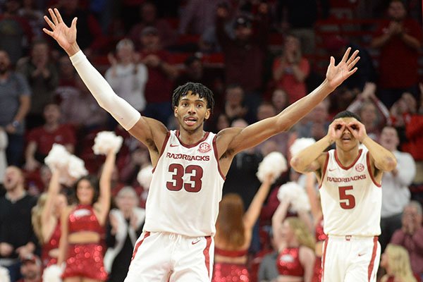 Arkansas guards Jimmy Whitt (33) and Jalen Harris (5) react to a made basket during a game against Vanderbilt on Wednesday, Jan. 15, 2020, in Fayetteville. 