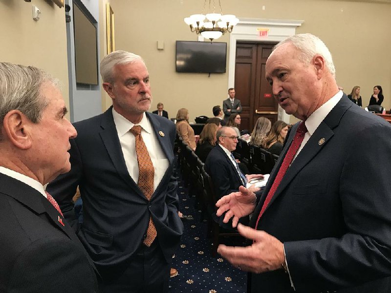Larry Walther (right), secretary of the Arkansas Department of Finance and Administration, talks Wednesday with U.S. House Budget Committee chairman John Yarmuth, R-Ky., (left) and Rep. Steve  Womack, R-Ark., before testifying at a committee hearing in Washington.
(Arkansas Democrat-Gazette/Frank E. Lockwood)
