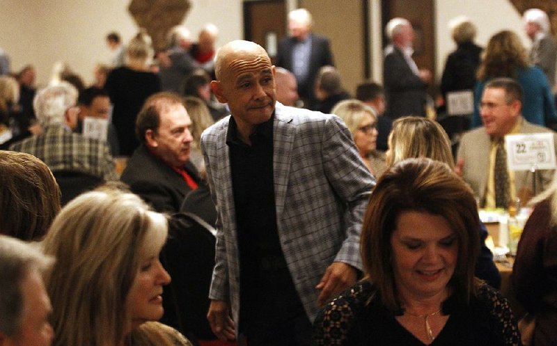 Hall of Fame jockey Mike Smith (center) received the first Jack Van  Berg Horse Racing Award at the Oaklawn Kickoff Banquet on  Wednesday night in Little Rock.
(Arkansas Democrat-Gazette/Thomas Metthe)