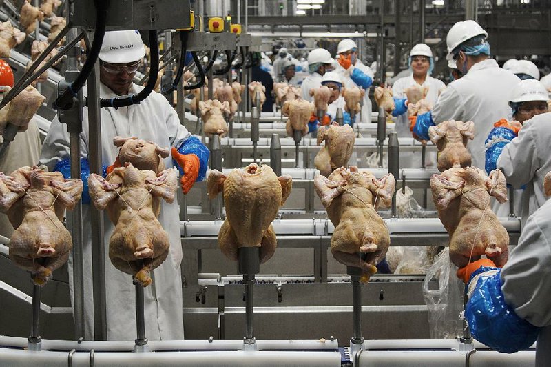 Workers process chickens last month at the Lincoln Premium Poultry plant in Fremont, Neb. Wholesale chicken prices rose in December. A big drop in beef prices kept down overall food costs, which fell 0.2%.
(AP/Nati Harnik) story.lead_photo.caption