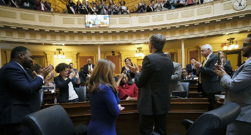 Democratic Delegate Jennifer Carroll Foy (seated center) gets applause Wednesday from fellow Equal Rights Amendment supporters in the Virginia House of Delegates in Richmond after she spoke for passage of the ERA resolution.
(AP/Richmond Times-Dispatch/Bob Brown)