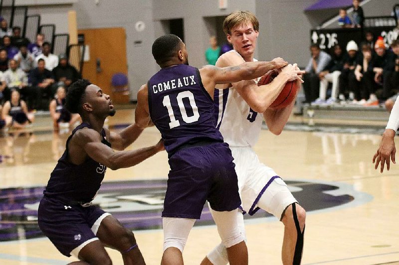 Central Arkansas junior center Hayden Koval (right) battles for possession of the ball with Stephen  F. Austin’s John Comeaux (center) and Roti Ware during the Bears’ loss to the Lumberjacks on Wednesday night at the Farris Center in Conway.
(Photo courtesy of the University of Central Arkansas)