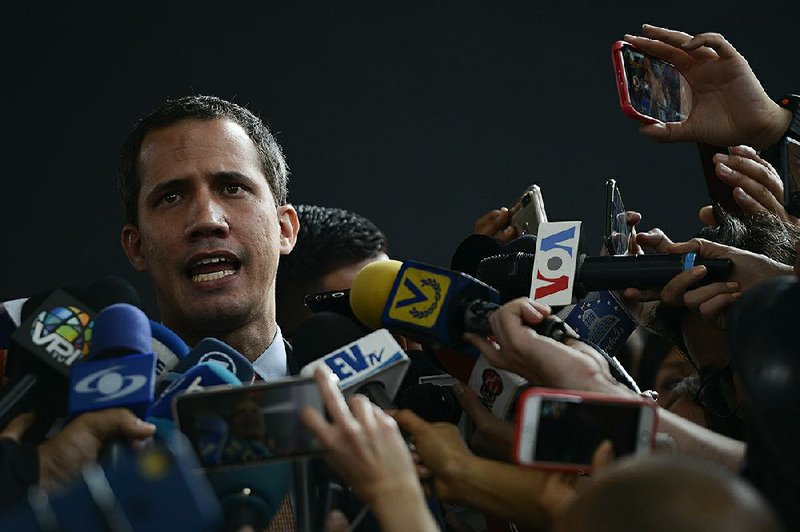 Venezuelan opposition leader Juan Guaido, speaking outside a theater in the Caracas suburb of El Hatillo where opposition leaders met Wednesday, said the attack outside the National Assembly building was an “ambush” carried out by the military and paramilitary groups armed by a “brutal and wild” dictatorship. More photos at arkansasonline.com/116venezuela/.
(AP/Matias Delacroix)