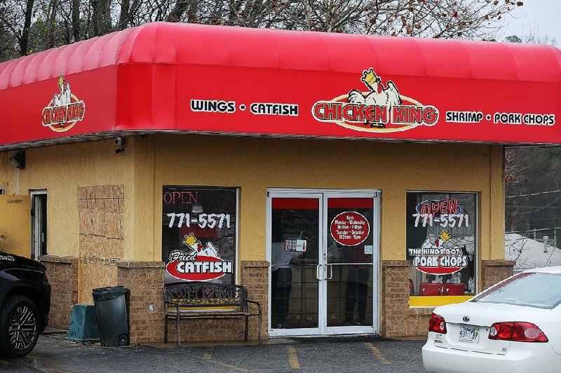 A window (left) is boarded up Wednesday at the Chicken King restaurant in North Little Rock after it was shattered when a man was thrown through it during a fight Tuesday afternoon.
(Arkansas Democrat-Gazette/Thomas Metthe)