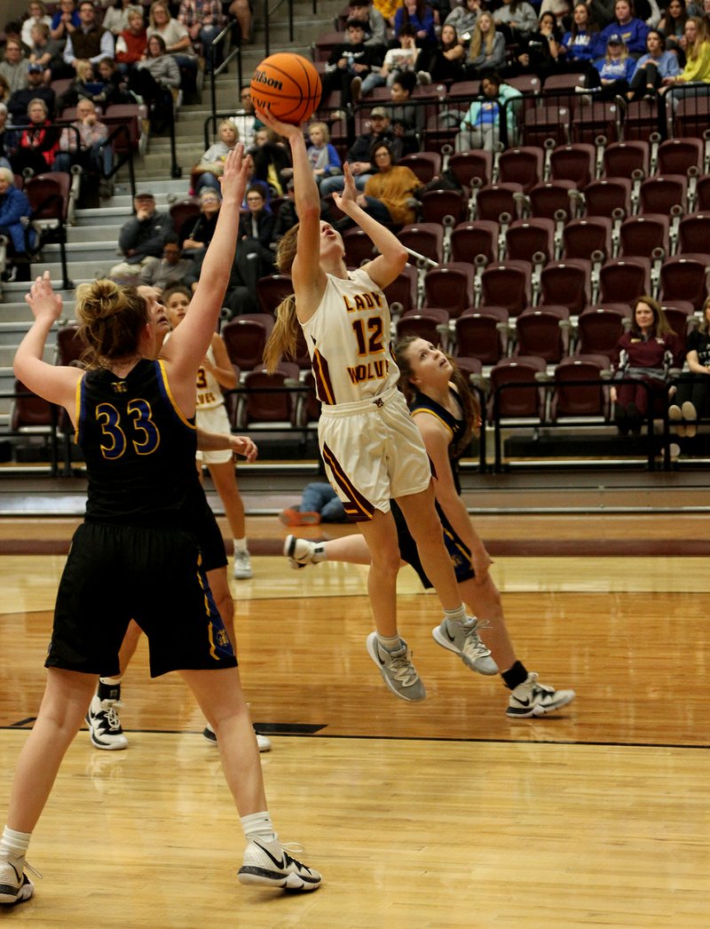 Lake Hamilton junior Aspen Thornton (12) puts up a shot as Lakeside sophomore Ronni Formby (33) and junior Erika Bittinger defend in Tuesday's game at Wolf Arena. - Photo by James Leigh of The Sentinel-Record