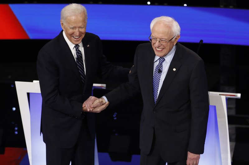 Democratic presidential candidates former Vice President Joe Biden, left, and Sen. Bernie Sanders, I-Vt., greet each other Tuesday, Jan. 14, 2020, before a Democratic presidential primary debate hosted by CNN and the Des Moines Register in Des Moines, Iowa. (AP Photo/Patrick Semansky)