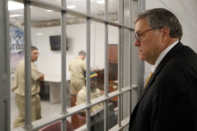 In this July 8, 2019, file photo, Attorney General William Barr watches as inmates work in a computer class during a tour of a federal prison. in Edgefield, S.C. The Justice Department is making changes to its system used to identify whether an inmate is likely to commit crimes again after release from prison to ensure the process is fair and effective. It's part of a sweeping criminal justice overhaul measure that was enacted last year. The federal Bureau of Prisons has already assessed nearly all of the 175,269 inmates in federal custody. But the Justice Department plans to re-screen all of those inmates under new guidelines, which officials say places a stronger emphasis on accurately measuring an inmate's change behind bars. - AP Photo/John Bazemore