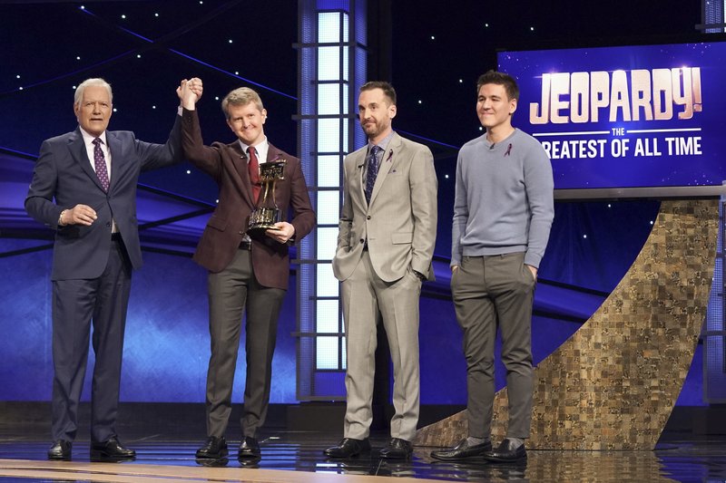 This image released by ABC shows host Alex Trebec, left, joining hands with contestant Ken Jennings after he won "JEOPARDY! The Greatest of All Time," as fellow contestants Brad Rutter and James Holzhauer look on. Jennings won the $1 million prize in the tournament that stretched out over four entertaining nights on ABC's prime-time schedule. - Eric McCandless/ABC via AP