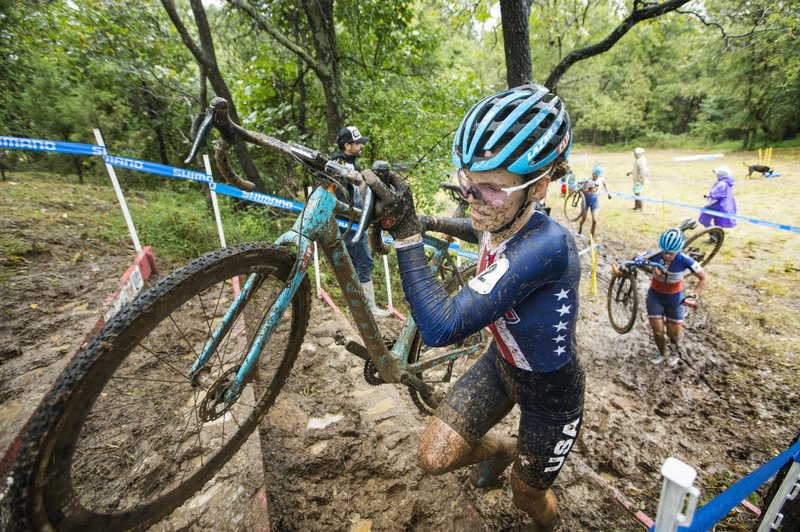 In this Oct. 2019 file photo, Clara Honsinger of the United States climbs a stair obstacle while racing in the UCI Elite Women race during the the Fayettecross cyclocross races at Centennial Park at Millsap Mountain in Fayetteville. Honsinger won the race. (NWA Democrat-Gazette/BEN GOFF)
