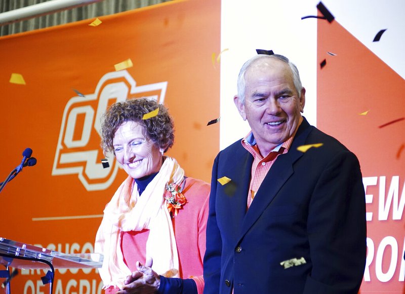 In this Wednesday, Jan. 15, 2020 photo, Kayleen and Larry Ferguson, who donated $50 million to Oklahoma State University, smile during the announcement in Stillwater, Oak.. Half of the donation will create an endowment for OSU agriculture students, and the other half will go toward the building of a new facility for agriculture research and learning at OSU. In recognition of the gift, the College of Agricultural Sciences and Natural Resources will be renamed the Ferguson College of Agriculture. (Tanner Holubar/The News Press via AP)