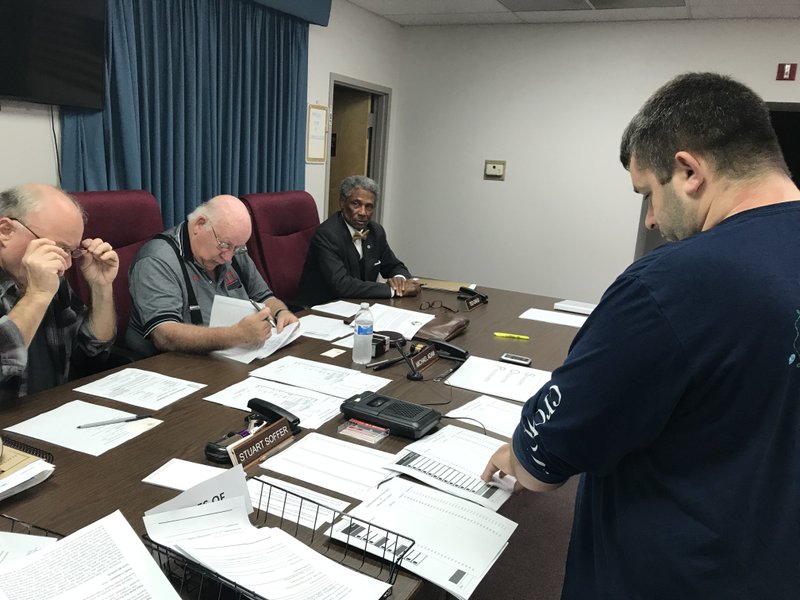 Jefferson County election commissioner Ted Davis, seated at right, has resigned from the commission.