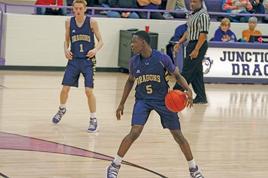 Terrance Armstard/News-Times In this file photo, Junction City's Harlandus Frazier looks for a teammate during the Dragons' contest against Dierks during the 2A South Regional Tournament at Junction City last year. On Thursday, the Arkansas Activities Association announced the 2020 tournament sites, but no Union County schools were successful in their bids to host postseason tournaments.