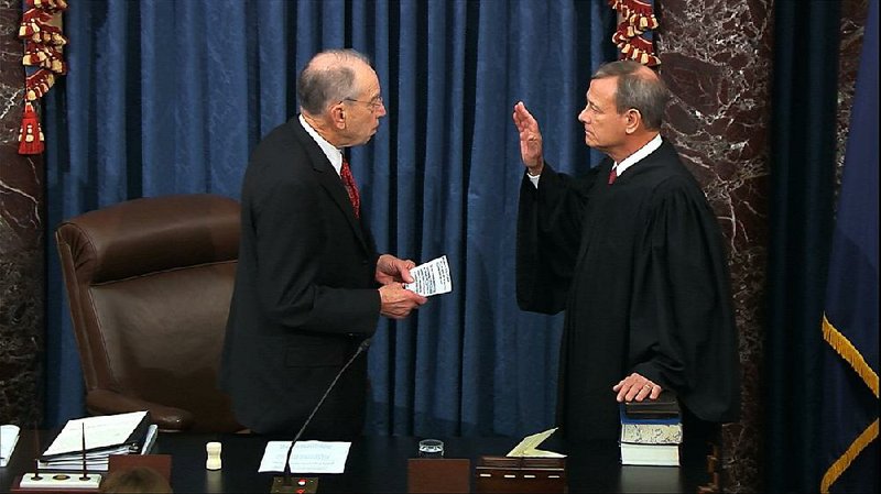 Sen. Chuck Grassley, R-Iowa, (top photo), president pro tempore of the Senate, swears in United States Chief Justice John Roberts on Thursday as presiding officer for the impeachment trial of President Donald Trump.  