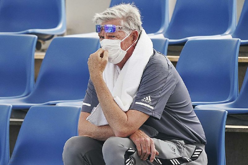 A fan wears a mask as smoke haze surrounded Melbourne Park on Tuesday in Melbourne, Australia. Smoke haze and poor air quality caused by wild- fires temporarily suspended practice sessions at the Australian Open ear- lier this week, a decision tournament director Craig Tiley defended.