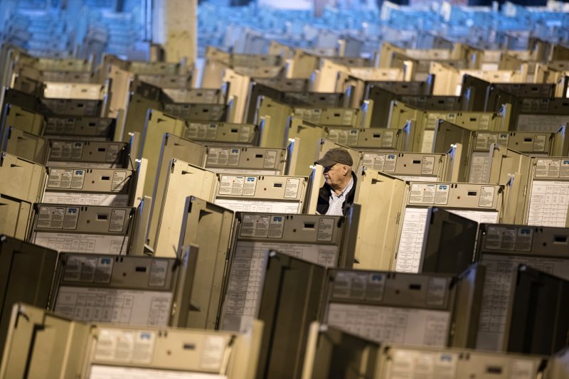 In this Oct. 14, 2016, file photo, a technician works to prepare voting machines to be used in the presidential election, in Philadelphia. The FBI, in a change of policy, is committing to inform state officials if local election systems have been breached, federal officials told The Associated Press. - AP Photo/Matt Rourke