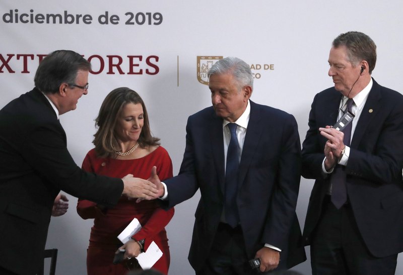 Mexico's Foreign Minister Marcelo Ebrard, left, shakes hands with Mexico's President Andres Manuel Lopez Obrador, as Deputy Prime Minister of Canada Chrystia Freeland, second left, and U.S. Trade Representative Robert Lighthizer look on, during an event to sign an update to the North American Free Trade Agreement, at the national palace in Mexico City, on Dec. 10. 2019. - AP Photo/Marco Ugarte