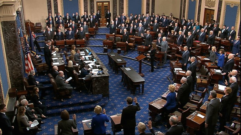 In this image from video, presiding officer Supreme Court Chief Justice John Roberts swears in members of the Senate for the impeachment trial against President Donald Trump at the U.S. Capitol in Washington on Thursday. - Senate Television via AP