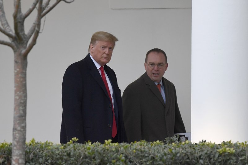 FILE - In this Jan. 13, 2020. file photo, President Donald Trump, left, and acting White House chief of staff Mick Mulvaney, right, walk along the colonnade of the White House in Washington.  (AP Photo/Susan Walsh, File)