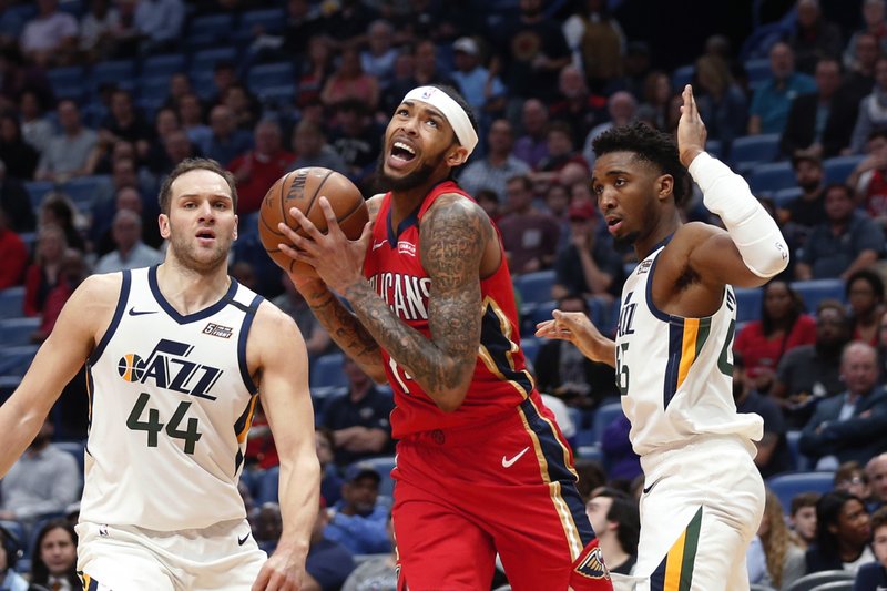 New Orleans Pelicans forward Brandon Ingram drives to the basket between Utah Jazz forward Bojan Bogdanovic (44) and guard Donovan Mitchell during the first half of Thursday game in New Orleans. - Photo by Gerald Herbert of The Associated Press