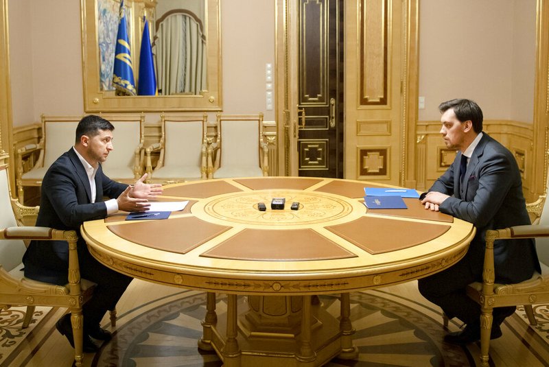 In this photo provided by the Ukrainian Presidential Press Office, Ukrainian President Volodymyr Zelenskiy, left, talks with Ukraine's Prime Minister Oleksiy Honcharuk in Kyiv, Ukraine, Friday, Jan.17, 2020. Honcharuk earlier submitted his resignation to parliament following a leaked audio recording which suggested he had criticised the president. (Ukrainian Presidential Press Office via AP)