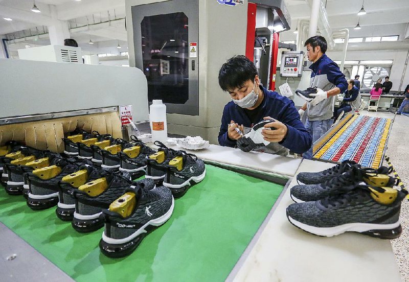 Factory workers make sneakers earlier this month in Jinjiang, China. The economic growth rate in China slowed in 2019 to 6.1%, the lowest in almost 30 years.