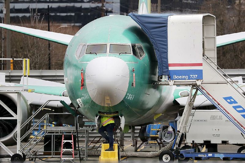 A technician works on a Boeing 737 Max jet in Renton, Wash., in December. Boeing’s problems with the jet helped create a mild recession in U.S. manufacturing in 2019, according to data released Friday by the Federal Reserve. The trade war with China and sluggish global economic growth contributed to the slowdown.
(AP/Elaine Thompson)