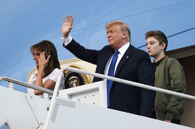 President Donald Trump arrives Friday at the Palm Beach, Fla., airport with his wife, Melania, and their son Barron for a weekend stay at Trump’s Mar-a-Lago resort.
(AP/Susan Walsh)