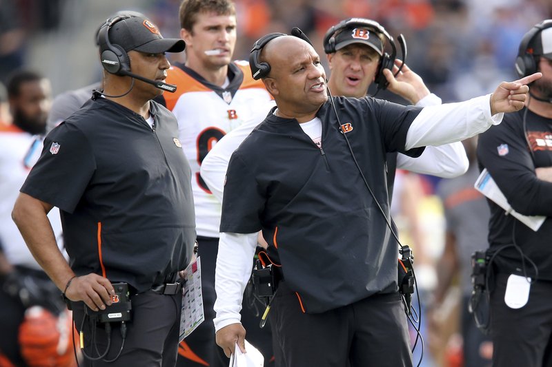 FILE - In this Dec. 9, 2018, file photo, Cincinnati Bengals special assistant to the head coach Hue Jackson, right, points something out to head coach Marvin Lewis during the second quarter of an NFL football game against the Los Angeles Chargers in Carson, Calif. Marvin Lewis and Hue Jackson are back on the sideline as head coaches this week for the NFLPA Collegiate Bowl. (Kareem Elgazzar/The Cincinnati Enquirer via AP, File)