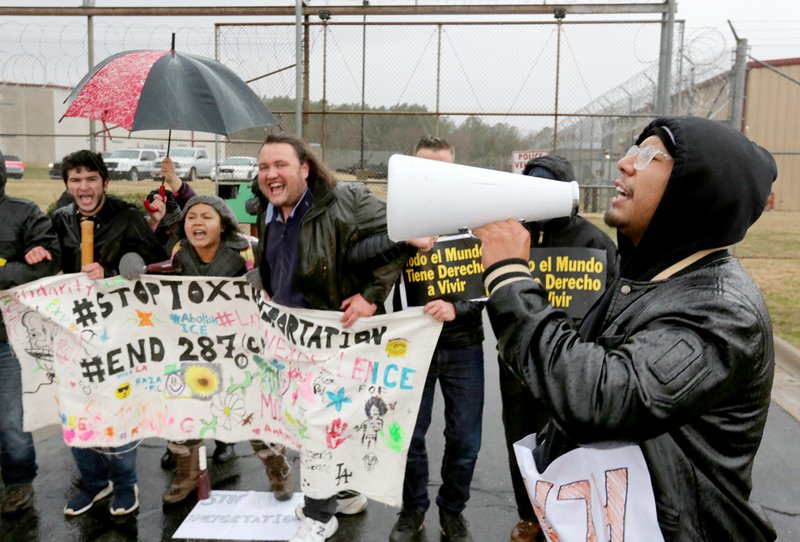 Kevin Rodriguez (right) leads a chant Friday with demonstrators outside the Washington County Sheriff's Office in Fayetteville. More than 30 people protested to call for the release of Alan Rodriguez, 24, arrested Sept. 19, in connection with criminal mischief and public intoxication. Alan Rodriguez is Kevin Rodriguez's older brother. Go to nwaonline.com/200118Daily/ and nwadg.com/photos for today's photo gallery. (NWA Democrat-Gazette/David Gottschalk)