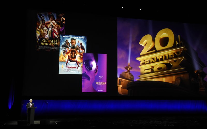 FILE - In this April 3, 2019, file photo, Alan Horn, chairman of The Walt Disney Studios, speaks underneath poster images for 20th Century Fox films during the Walt Disney Studios Motion Pictures presentation at CinemaCon 2019, the official convention of the National Association of Theatre Owners (NATO) at Caesars Palace in Las Vegas. Disney is dropping the word &#x201c;Fox&#x201d; from the movie studios it acquired as part of last year's $71 billion purchase of Fox's entertainment business, according to published reports. According to trade publication Variety, 20th Century Fox will become 20th Century Studios, while Fox Searchlight Pictures will be Searchlight Pictures. Disney will still run them as separate studios within the company. (Photo by Chris Pizzello/Invision/AP, File)