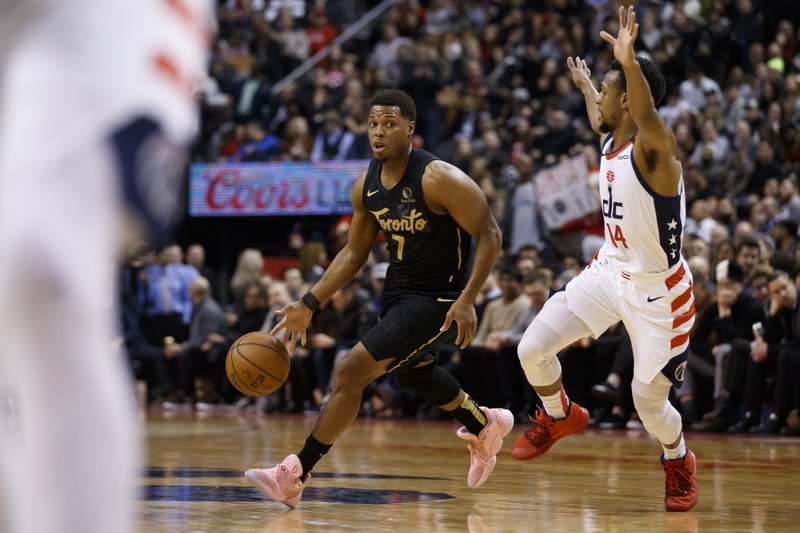 Toronto Raptors guard Kyle Lowry (7) drives against Washington Wizards guard Ish Smith (14) during the first half of Friday's game in Toronto. - Photo by Cole Burston of The Canadian Press via The Associated Press